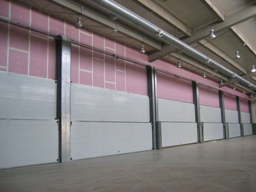 Porte coulissante verticale - Talleres Alfa Torres - multi-lames / en métal / industrielle
