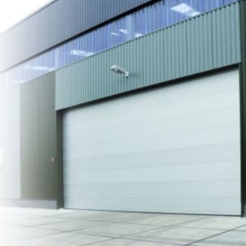 Porte coulissante - Loading Systems International - sectionnelle / industrielle / de hangar